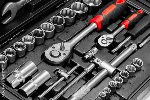 Schilderij op canvas Red ratchets stand out among neatly arranged tools