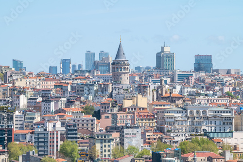 view of a urban zone with the galata tower in the center and partial clear sky in the city of istanul, turkiye