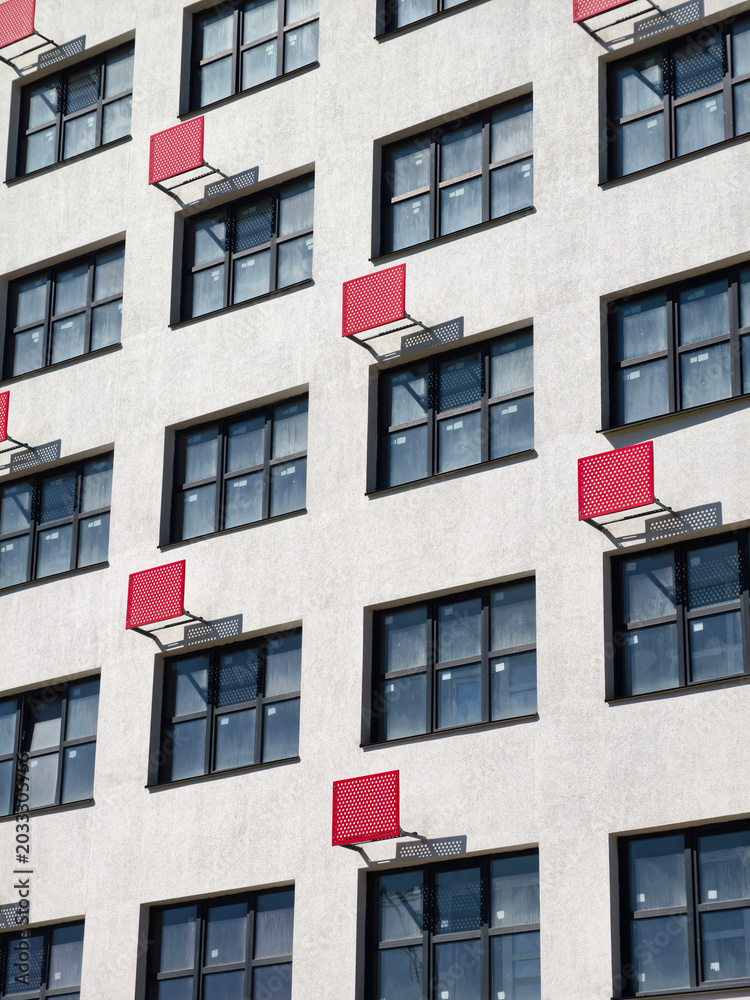 Fototapeta premium A newly built residential complex featuring red outdoor air conditioner brackets