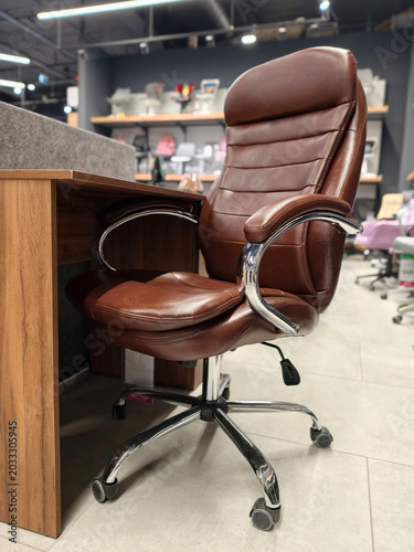 Obraz na plátně Brown leather office chair with adjustable height and rolling casters, sold at a