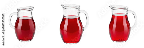 Canvas Print Set and collection of fresh red fruit juice or syrup in a clear glass pitcher ca