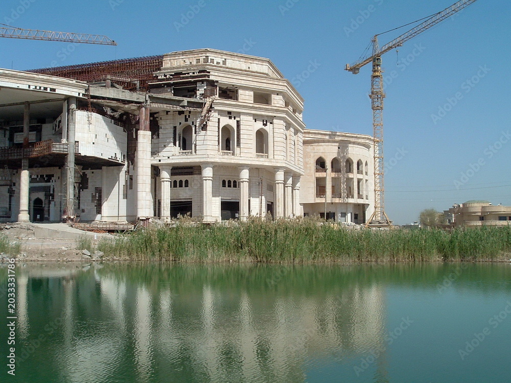 Fototapeta premium Crane over an unfinished Republican Guard palace on Victory Base in Baghdad, Iraq, during Operation Iraqi Freedom