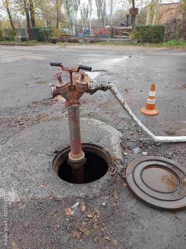 A fire standpipe installed on an underground hydrant to draw water from the water supply network. A fire standpipe is used by firefighters to connect fire hoses and fill the tanks of fire trucks with