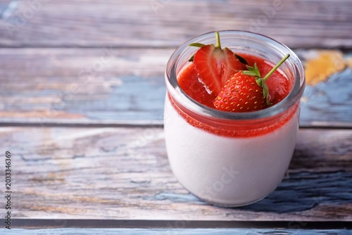 Strawberry panna cotta with strawberry sauce and fresh strawberries