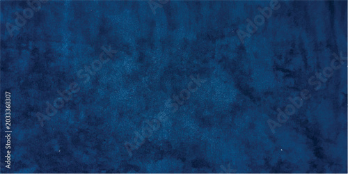 An old dark blue grunge concrete wall texture with a rough black stone surface and vintage paper pattern creates a blank dirty backdrop for a weathered design
