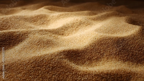 A close up view of warm fine textured earth or sand surface creating an abstract natural pattern