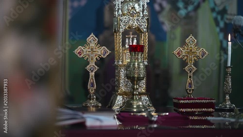 Golden altar setup with ornate crosses and chalice in a church setting