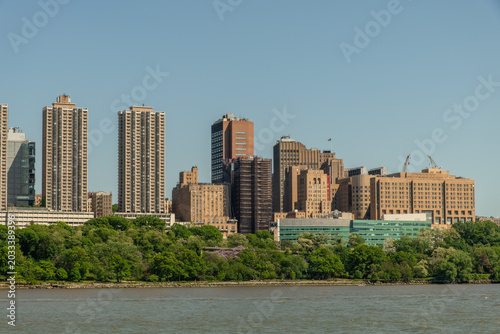 Scenic Washington Heights shore vista on a sunny summer day taken from a boat, Manhattan, New York City