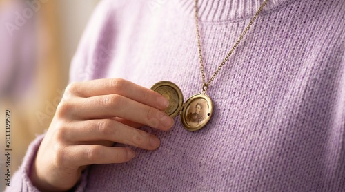 Woman holding a vintage locket with portrait