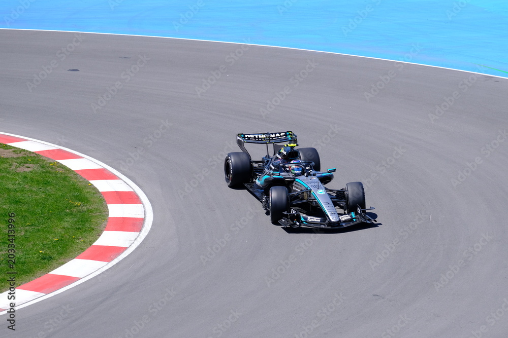 Naklejka premium May 24, 2026, Montreal, Canada, Mercedes F1 car racing through Circuit Gilles Villeneuve corner. g.
