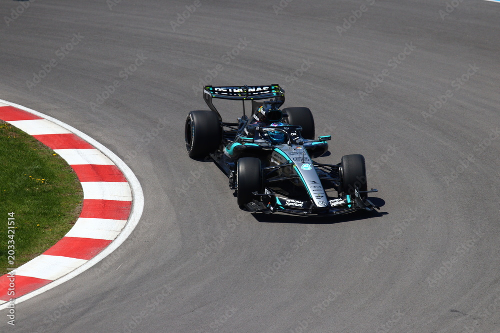 Obraz premium May 24, 2026, Montreal, Canada, Mercedes F1 car racing through Circuit Gilles Villeneuve corner. g.