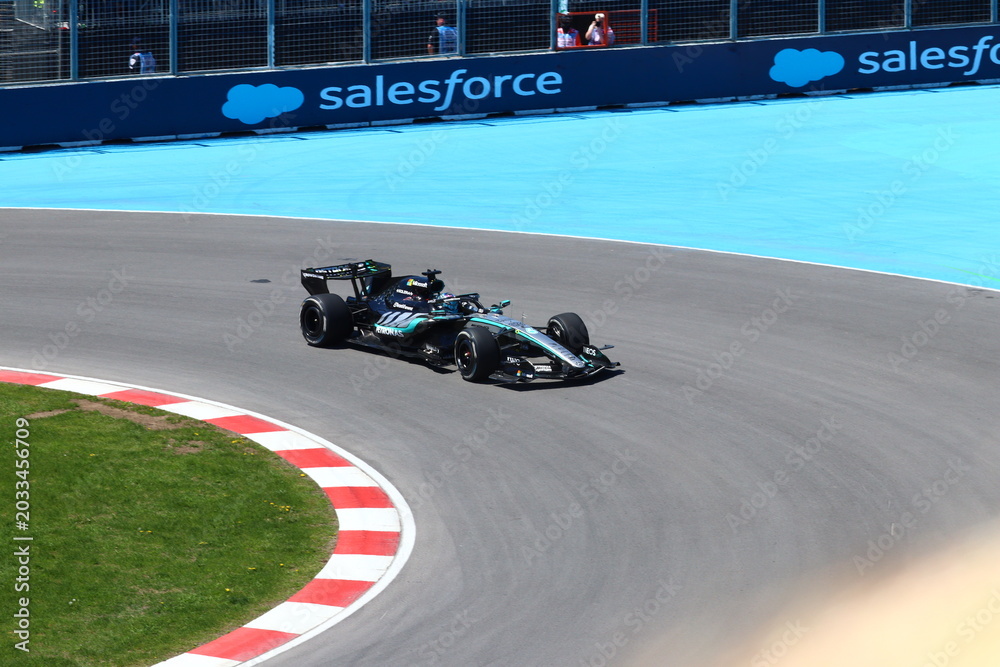 Obraz premium May 24, 2026, Montreal, Canada, Mercedes F1 car racing through Circuit Gilles Villeneuve corner. g.