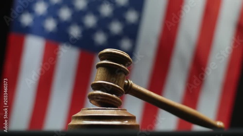 Judges Gavel On Block With Waving American Flag Background