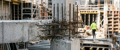 Close-up construction site with steel reinforcement and concrete columns