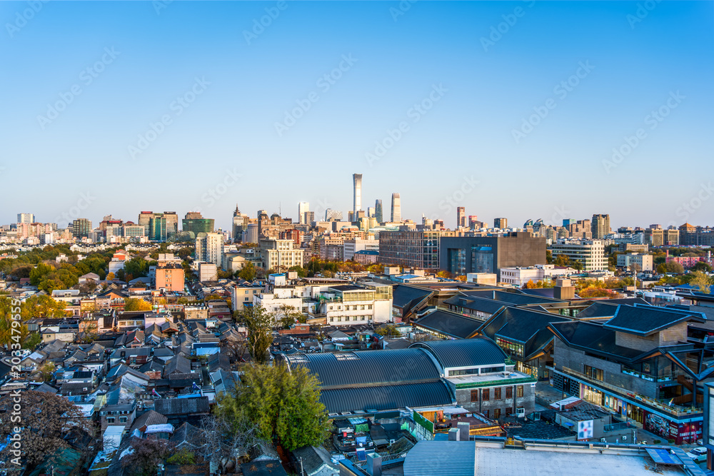 Fototapeta premium Aerial panoramic view of the blend of old and new skyline in Beijing's old city hutongs and CBD business district.