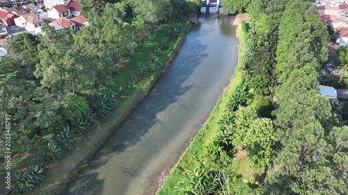 dredging mud on the riverbank in densely populated areas in the city center using heavy equipment such as excavators and dump trucks