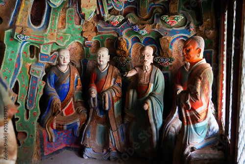 Canvastavla Ancient colorful statues of arhat disciples inside a scenic cave grotto at the s