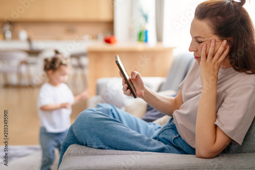 Female using smartphone at home internet watching videos, social networks
