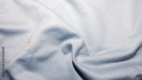 ​Close-up of light blue fabric texture with pilling background