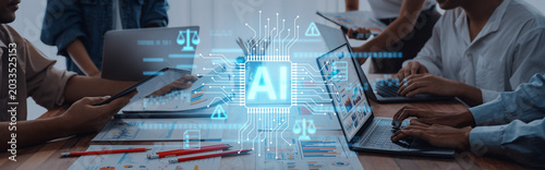 Fotografie A dynamic scene depicting business professionals engaging with laptops and innovative AI graphics, showcasing the impact of technology on teamwork and productivity in the modern workplace