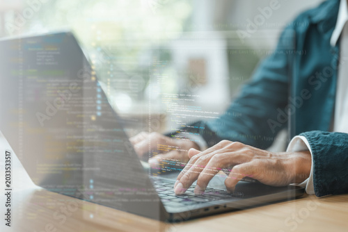 Programmer coding software on laptop with digital interface and source code overlay, representing artificial intelligence, web development, and modern technology engineering.
