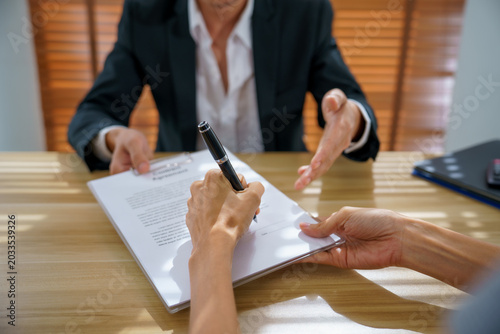 Contract agreement signature signing pen document shape business moment as hands complete paperwork during meeting and negotiation, conveying trust and clarity at office desk with window light