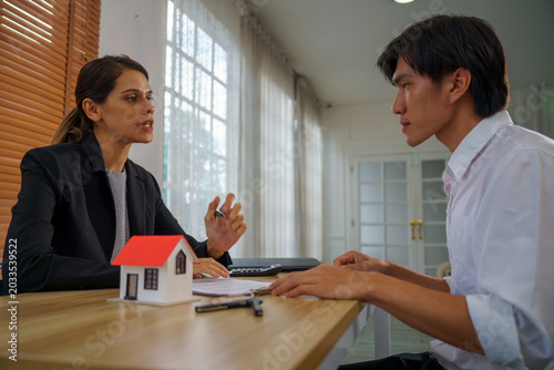 Real estate consultation agent client meeting contract mortgage loan paperwork serious contract and mortgage loan paperwork for client and agent in consultation and meeting