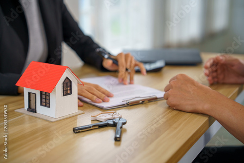 Real estate house contract key mortgage sale purchase agreement as agent and client sign calmly hopefully confirming clearly and moving forward together