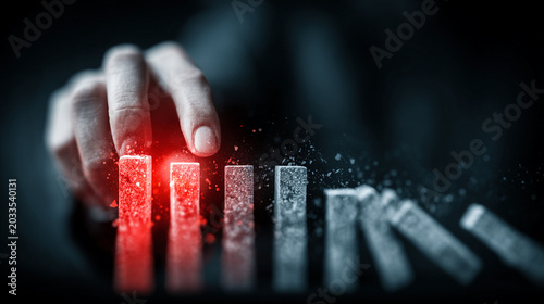 Business risk management concept with bar graph and hand pointing at red bar in dark setting