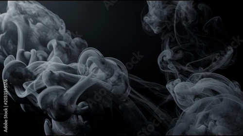 Smoke swirling in dark space.