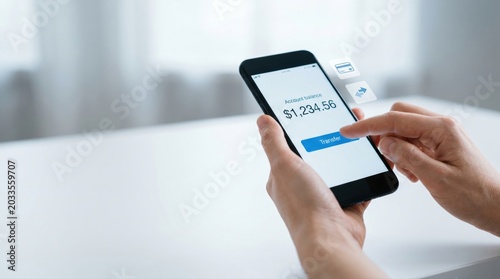 Hands Using Smartphone for Mobile Banking and Money Transfer with Visible Account Balance on Screen