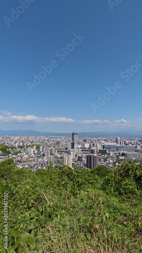 Static high angle view of the cityscape around Kumamoto Station in May 2026