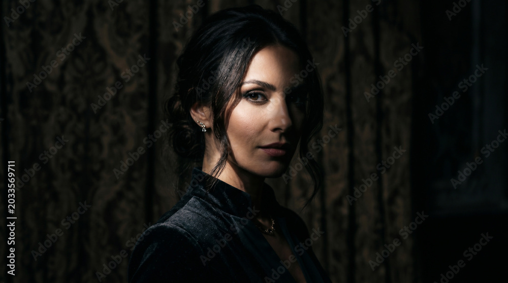 Fototapeta premium Close-up Cinematic Portrait of Sophisticated Woman in Black Dress