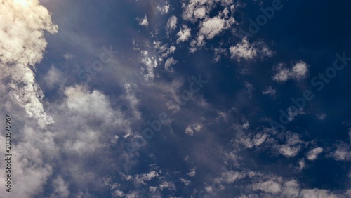 Dramatic Blue Sky with White Cumulus Clouds - Beautiful Fluffy Cloud Formation and Sunlight Rays, Natural Atmosphere Background for Nature and Landscape Photography