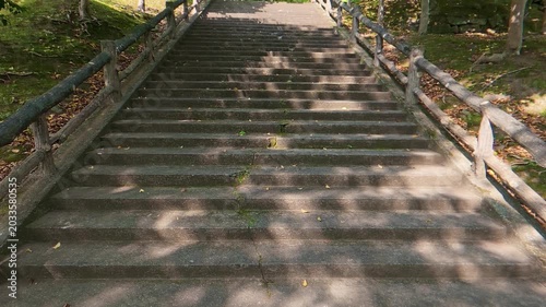 Low angle shot of looking up a wide stone staircase slowly