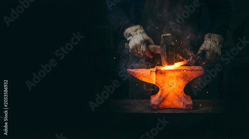 Blacksmith hammering glowing hot metal on anvil in dark workshop for custom metalwork and forging projects