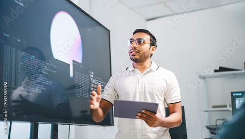 Adult indian engineer programmer presentation coding AI artificial intelligence algorithm coder training monitor developer expertise programming IT technology career
