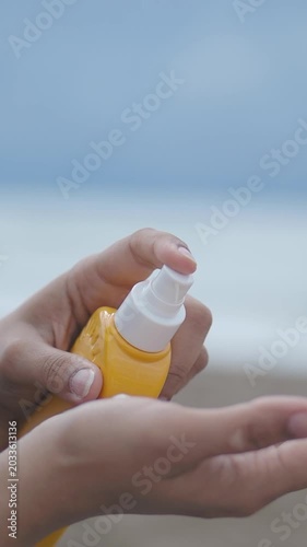 Applying sunscreen at the beach during daytime hours