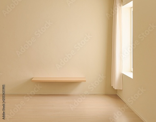 Minimalist interior design featuring a floating shelf against a pale yellow wall with natural light streaming in from a window with sheer curtains