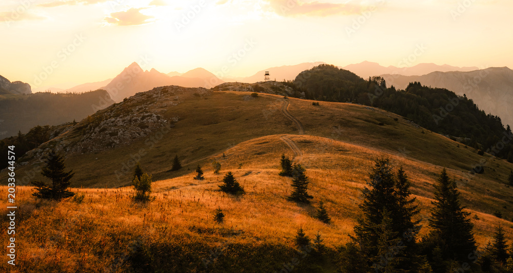 Obraz premium Sunset over the Maglic mountain massif seen from Prijevor saddle in Sutjeska National Park, the highest peak of Bosnia and Herzegovina at golden hour.