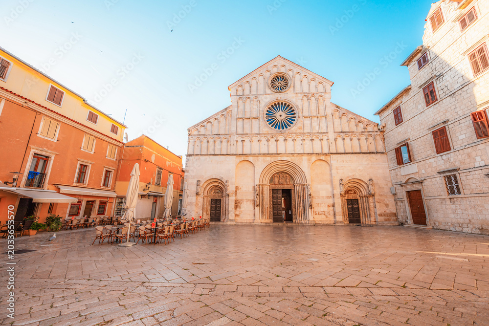 Fototapeta premium Zadar, Croatia. Old town street of Zadar with the Church of St. Donatus and the bell tower of the Cathedral of St. Anastasia at sunset.