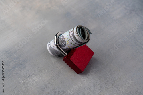 Bilde på lerret A roll of hundred-dollar bills secured tightly inside a red padlock