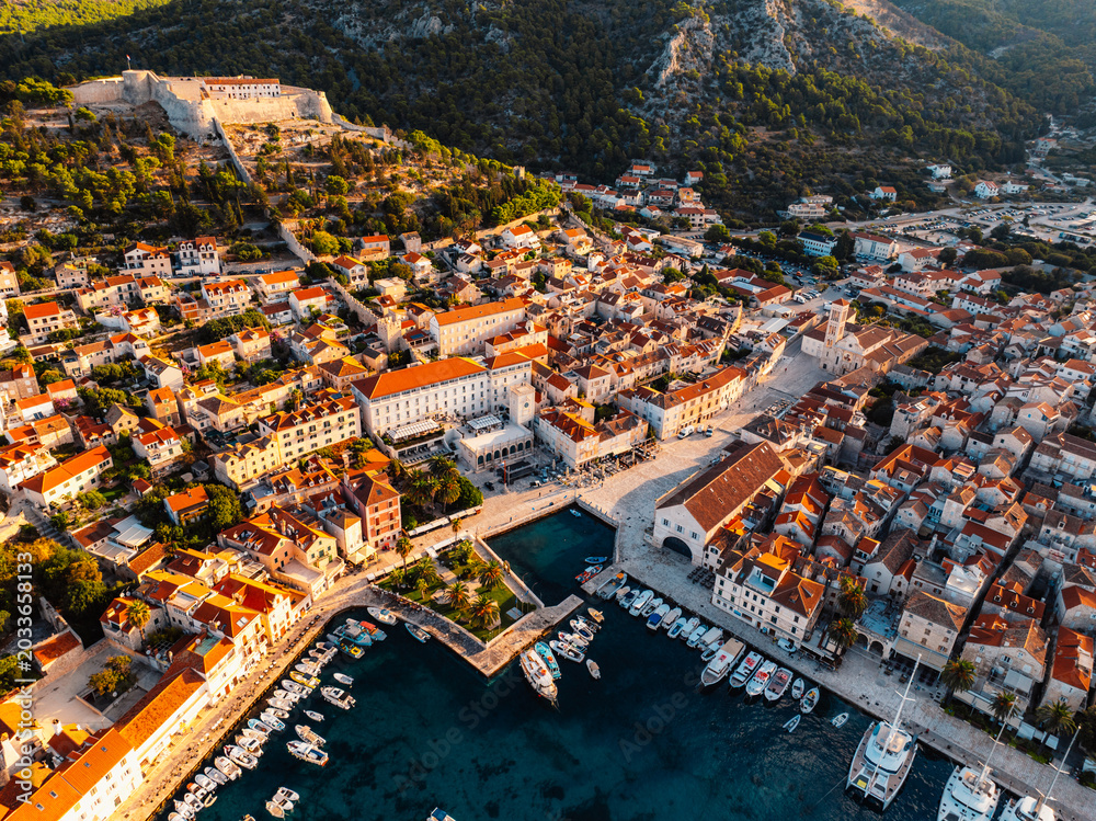 Fototapeta premium Aerial view of the historic Hvar town and the Spanish Fortress (Fortica) overlooking the harbor and Adriatic sea, Hvar island, Dalmatia, Croatia.