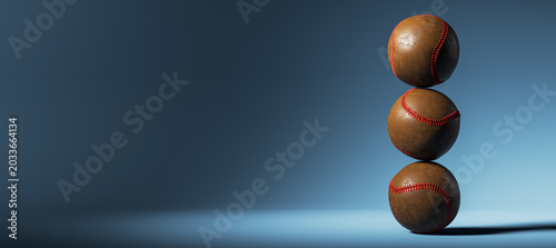 Three stacked worn baseball balls balanced on blue gradient background in mod...