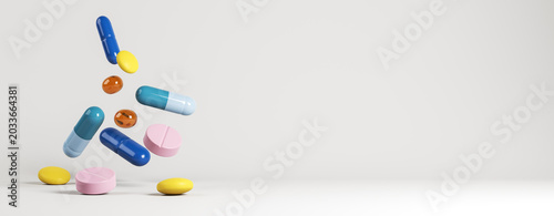 Colorful assorted medicine capsules and tablets floating in midair against a clean light background as a modern pharmacy abstract banner design. 3D Rendering