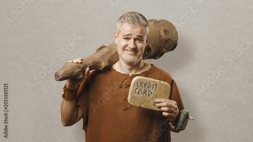Slika na platnu Funny Prehistoric Caveman Holding a Stone Credit Card - Ancient