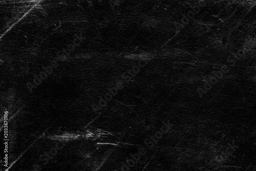 Old black stucco wall with white scratches and scuffs texture. textured grunge black board with chalk