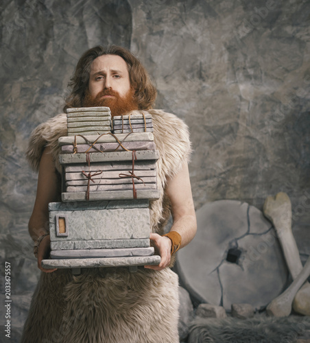 Stressed Stone Age employee carrying many files