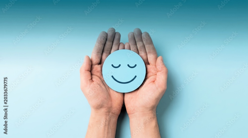 Fototapeta premium Two hands gently cradling a light blue circular icon featuring a peaceful and happy face