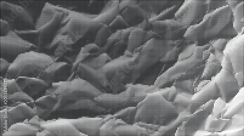 A gray-scale image showcases rugged, crumpled surfaces on a neutral background with sharp, defined folds and creases.